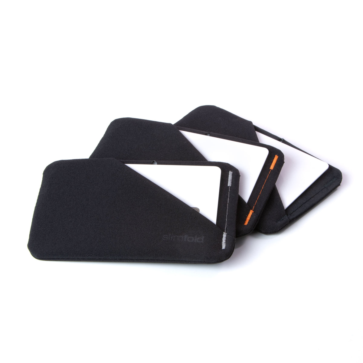 Three black slim wallets sleeves with a white card partially inserted, arranged in a fan shape on a clean white background. all-groups