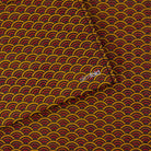 A close-up of a SlimFold Micro Tyvek wallet with a repeating Japanese-style wave pattern in mustard yellow, red, and dark brown, with a small white 'simfold' logo printed in the center.